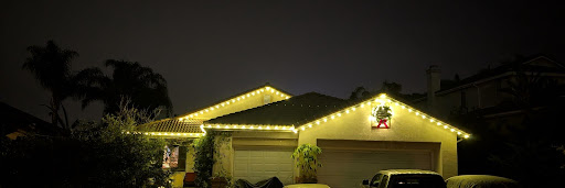 Warm holiday lights installed along a North County rooftop